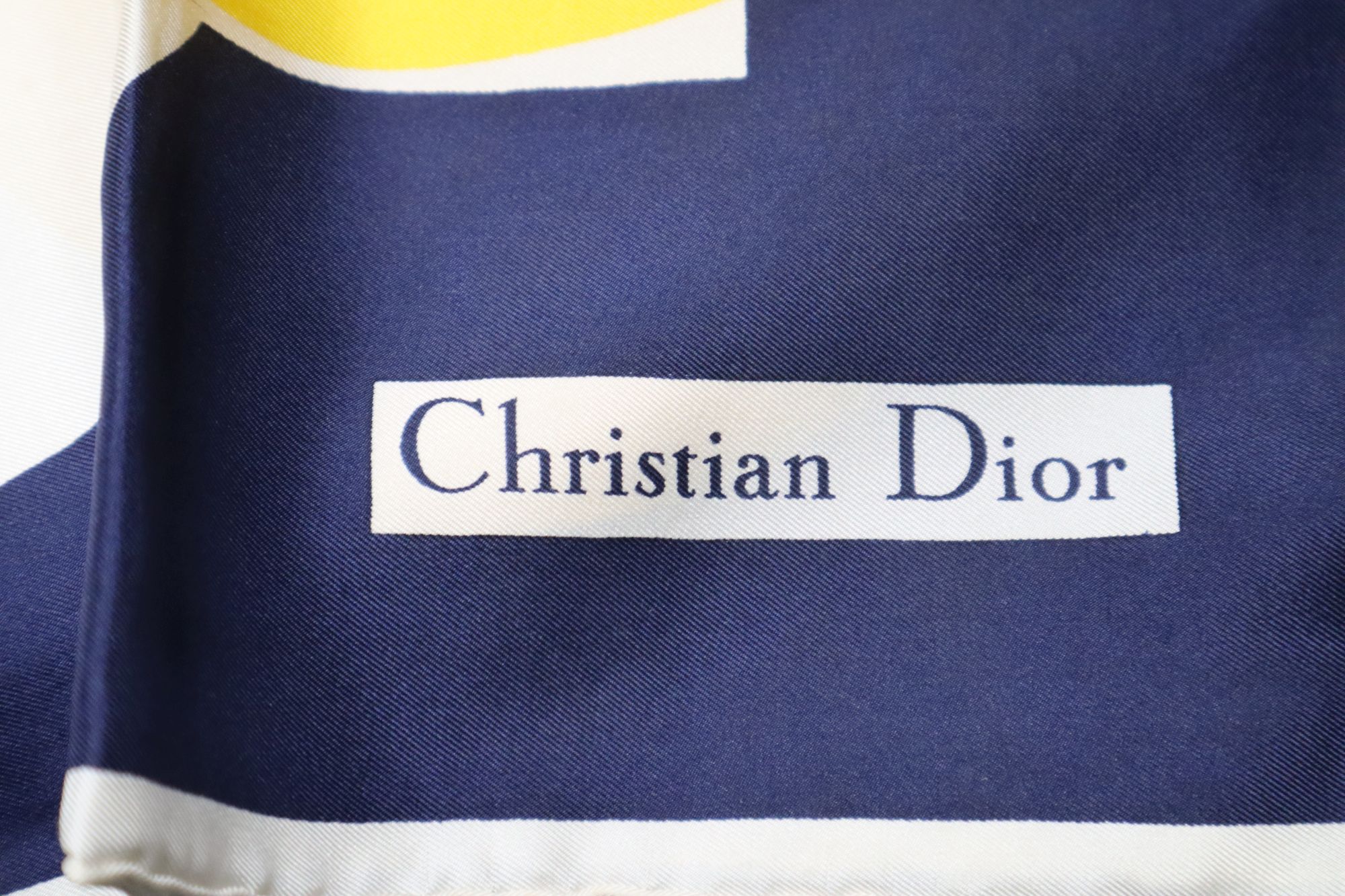 A Christian Dior blue, yellow and white circle design silk scarf and miscellaneous items,